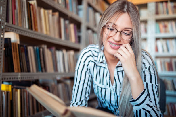 istock Beautiful girl in a library 1184148707