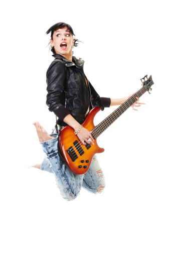 Young woman singing and playing electric bass on a show