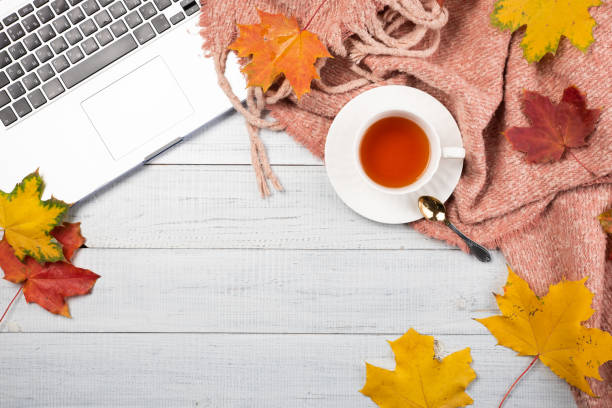 istock Workspace with red and yellow maple leaves, laptop 1184152179