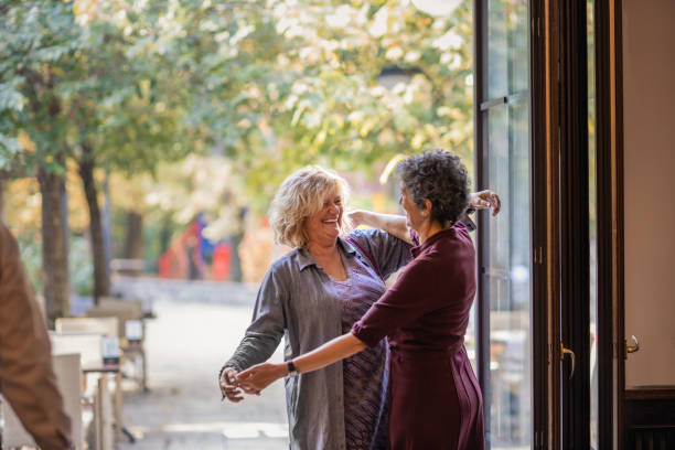 istock Friends Greeting And Hugging In Restaurant 1184152433