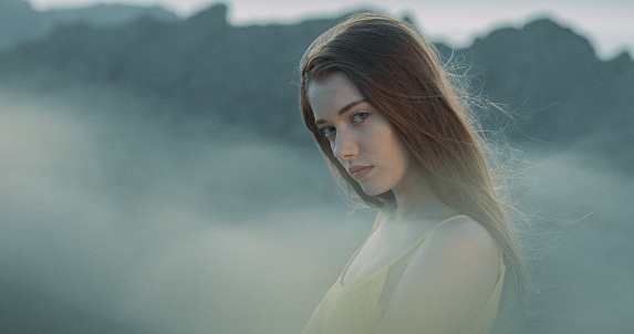 Young girl posing on the mountain top