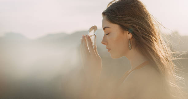 Woman's head with a healing crystal Woman on mountain, crystal healing crystal faces stock pictures, royalty-free photos & images