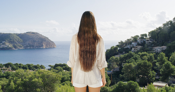Girl in white t-shirt enjoys the view from the terrace