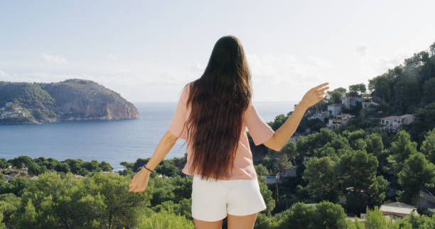 istock Girl enjoys the view from the terrace 1184155262