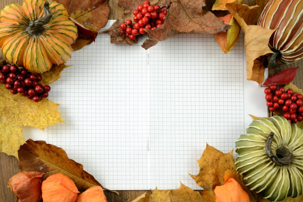 autumn pumpkin decoration with checkered copy space paper background. top view.