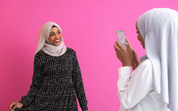 istock girls taking photos on smart phone 1184158151