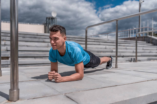 Athletic man, standing in bar, training abs and back muscles, training in summer day in city, an active lifestyle, modern fitness workout, sportswear t-shirt, shorts, sneakers hombre atlético, de pie en el bar, entrenamiento abdominales y músculos de la espalda, entrenamiento en el día de verano en la ciudad, un estilo de vida activo, entrenamiento de fitness moderno, camiseta de ropa deportiva, pantalones cortos, zapatillas.