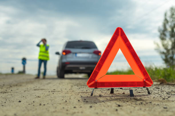 istock Vehicle breakdown and warning triangle on the road 1184164841