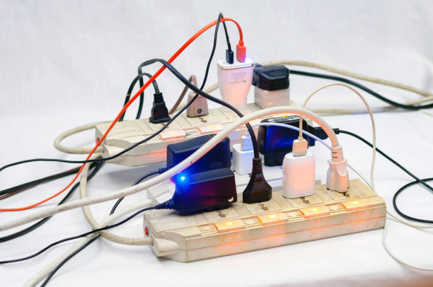 istock Many electrical cords connected to a single power strip or extension block. 1184164852