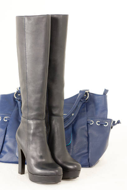 istock fashionable black boots with a handbag 1184166114