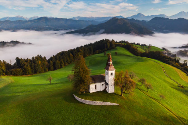 Autumn landscape of a beautiful church on the top of a hill Autumn landscape of a beautiful church on the top of a hill, in Slovenia gorenjska stock pictures, royalty-free photos & images