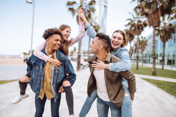 istock friends piggyback in barcelona 1184169347
