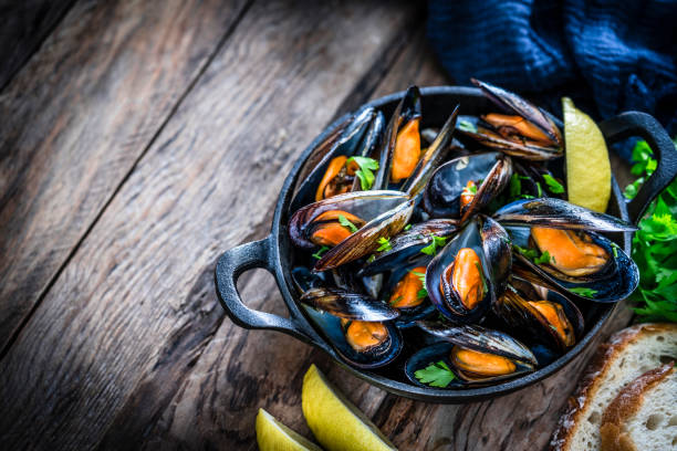 istock Steamed mussels in a cooking pan with copy space 1184169375