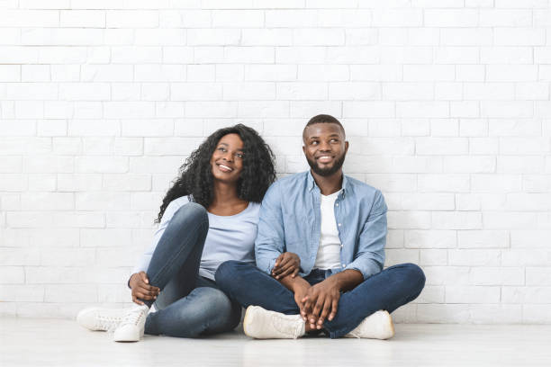 istock Dreamy black couple sitting on floor, planning interior 1184170826