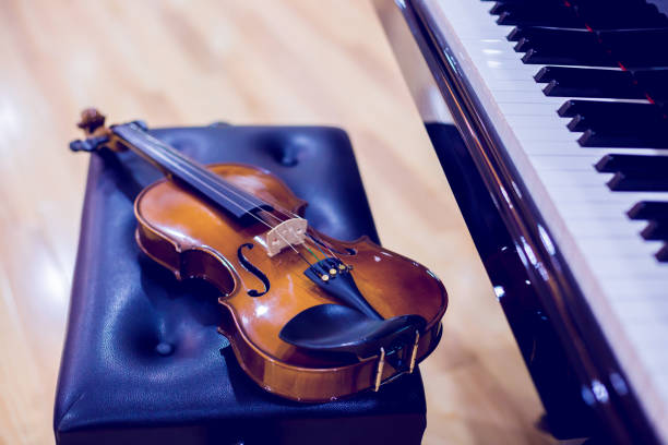 istock Violin and piano on wooden background. 1184170856