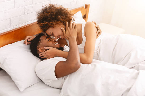 African couple of lovers relaxing in bed at home African couple of lovers relaxing in bed at home, enjoying each other, copy space sex and reproduction stock pictures, royalty-free photos & images