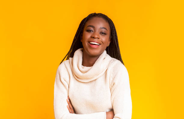 istock Cheerful afro winter girl laughing over yellow studio background 1184175448