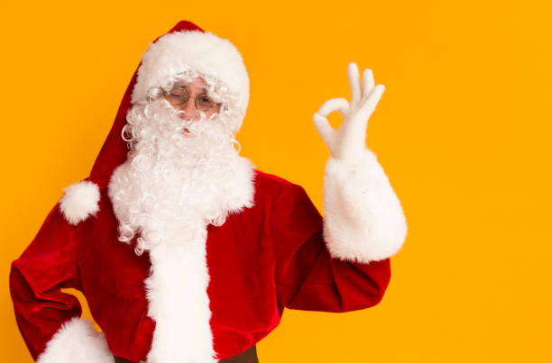istock Cheerful Santa Claus with white beard showing ok sign 1184175752