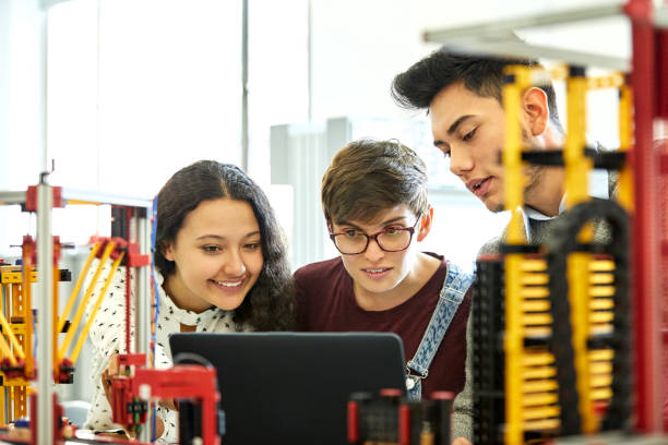 istock Students discussing over laptop in university 1184176858