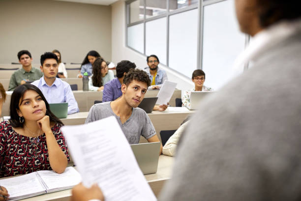 istock Students listening to teacher in lecture hall 1184176907