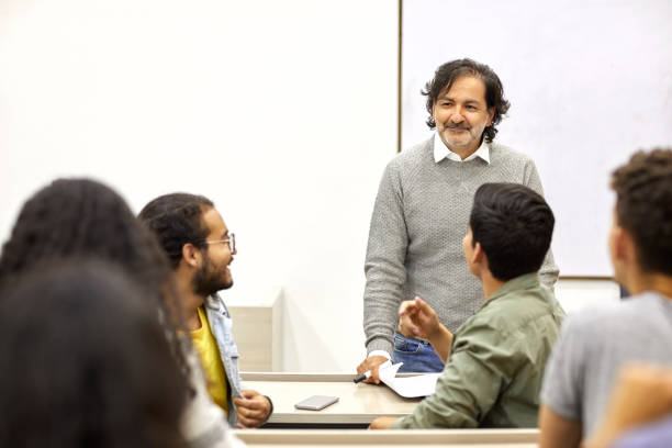 istock Teacher listening to students in lecture hall 1184177166