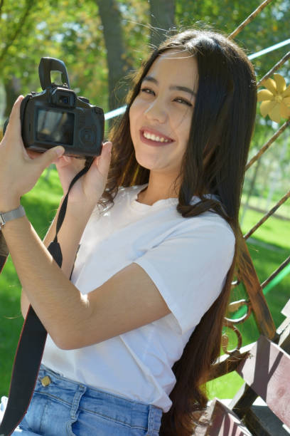 istock girl with photo camera 1184179291