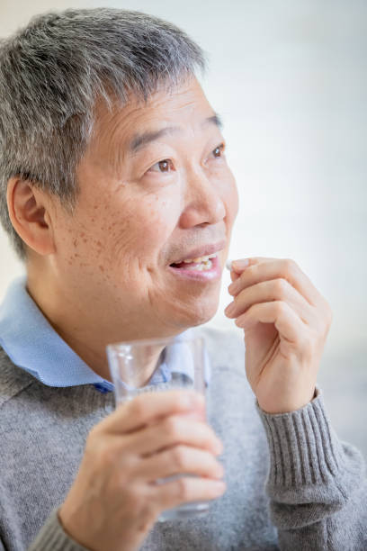istock old asian man take medicine 1184181816