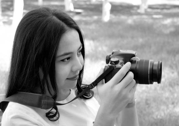 istock girl with photo camera 1184182282