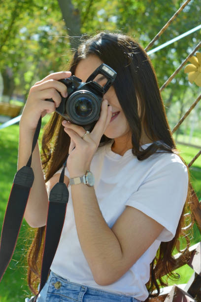 istock girl with photo camera 1184182322