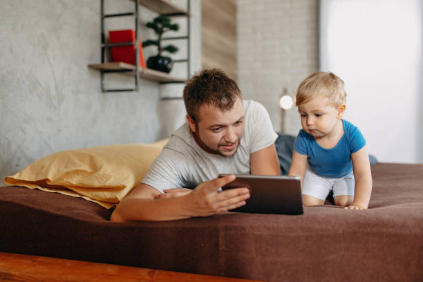 istock Father and son in bed, happy time on bed 1184182361