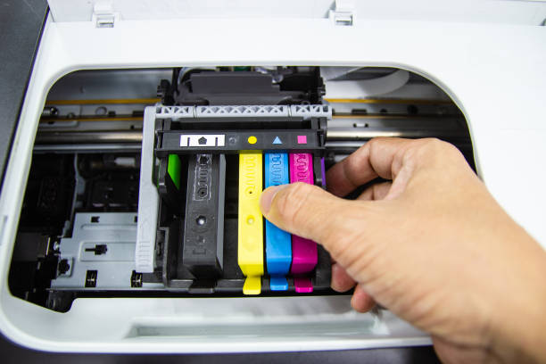 istock Technicians are install setup the ink cartridge of a inkjet printer 1184183305