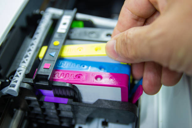 istock Technicians are install setup the ink cartridge of a inkjet printer 1184183325