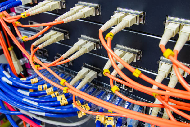 istock cable network , fiber optic cable connect to switch port in server room 1184183348
