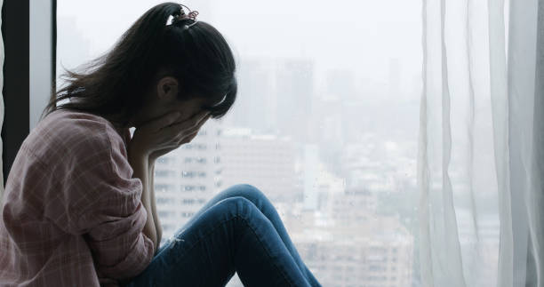 istock woman cry near by window 1184183472