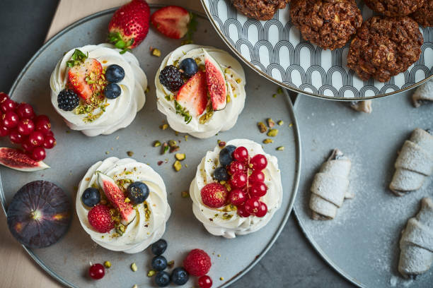 istock Mini Pavlova Cakes meringue dessert with berries 1184183484