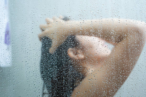 istock Woman taking a shower. 1184183566