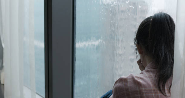 istock woman cry near by window 1184184164