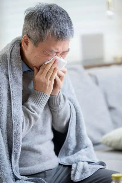 Photo of old asian man get a cold