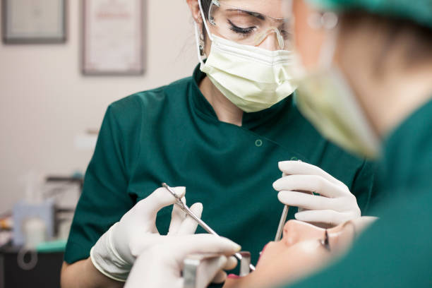 Dental surgery. Team dental surgeons working in dental office Dental surgery. Team dental surgeons working in dental office dental drill stock pictures, royalty-free photos & images