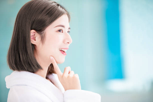 woman has health skin close up of beauty asian woman has health skin and touch her chin human eye close up eyeball side view stock pictures, royalty-free photos & images
