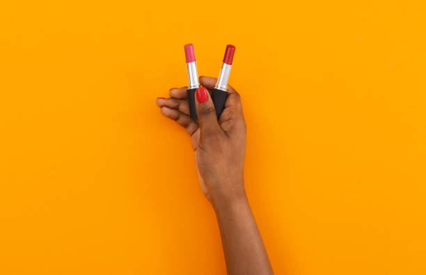 istock Matte red and pink lipsticks in black female hand 1184188041