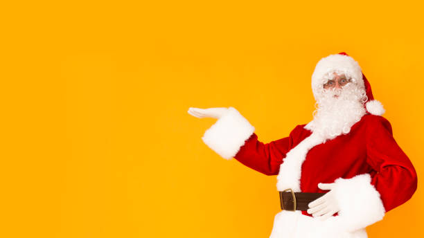 istock Santa Claus presenting with hand copy space for Christmas text 1184188486