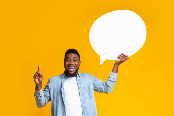 istock Inspired african american guy man holding empty speech bubble 1184188635