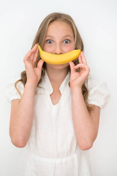 istock Girl with banana 1184190076
