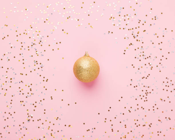 istock Creative decoration ball on pink background with confetti 1184190353