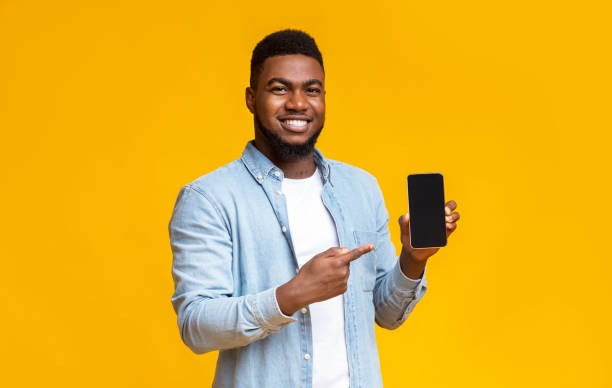 istock Handsome black man demonstrating cellphone with black screen 1184191122