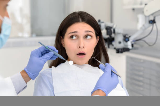 istock Nervous woman looking at dentist before treatment 1184191665