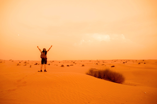 an asian woman traveling alone in desert and old city in dubai,