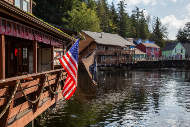 Ketchikan, Alaska, United States - September 26, 2019: Beautiful View of an American Flag at a Famous Creek Street in a small touristic town on the Ocean Coast during a sunny morning.