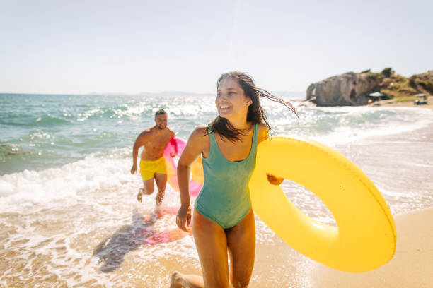 Our summer Photo of smiling couple at the beach beach holiday stock pictures, royalty-free photos & images